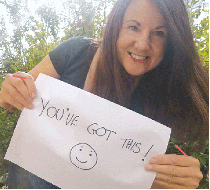 Person holding a piece of paper that says 'You've Got This'