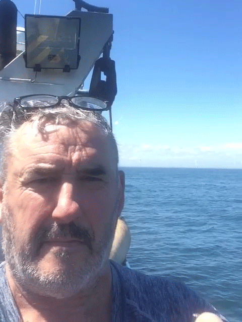 Person on a boat putting his thumb up